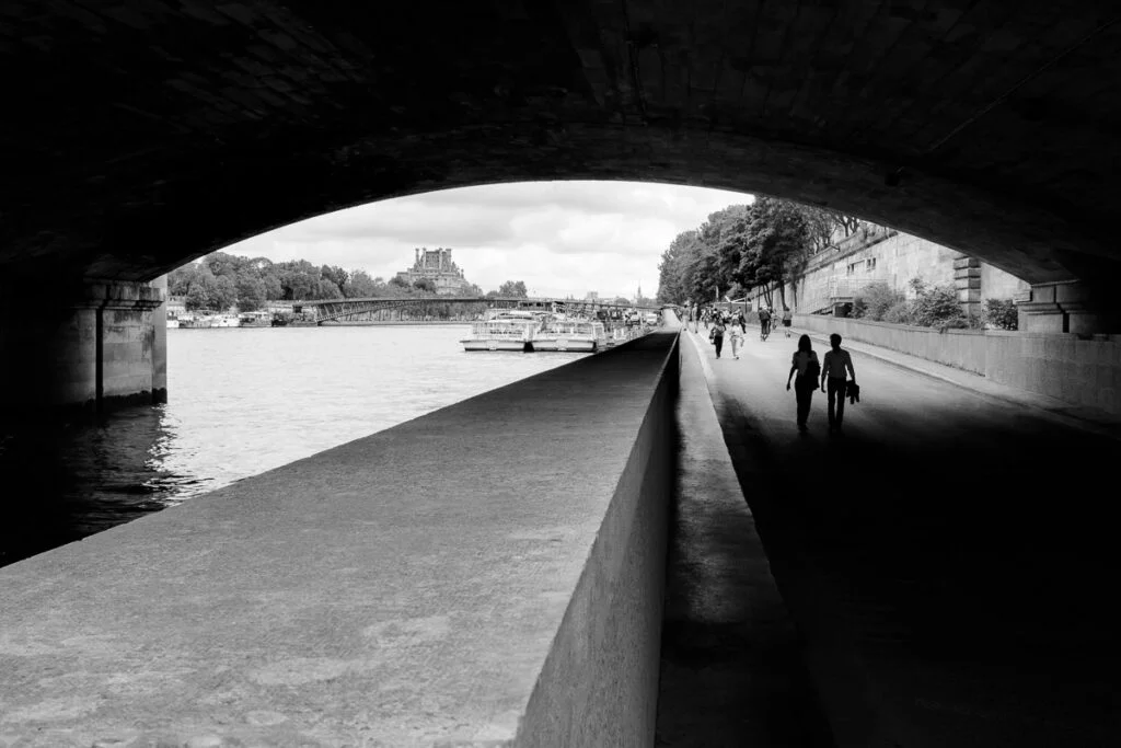 Couple walking under the bridge