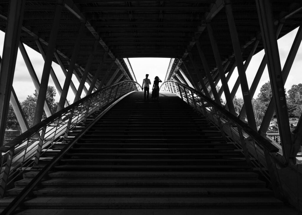 Couple going down the Leopold Sedar-Senghor bridge