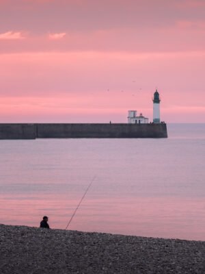 Fisherman in Mers-les-Bains beach at sunset
