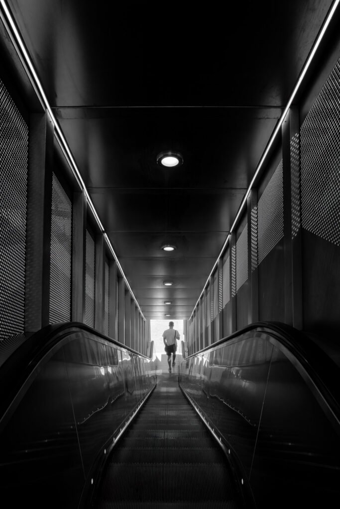 Man down the escalator in La Defense, Paris