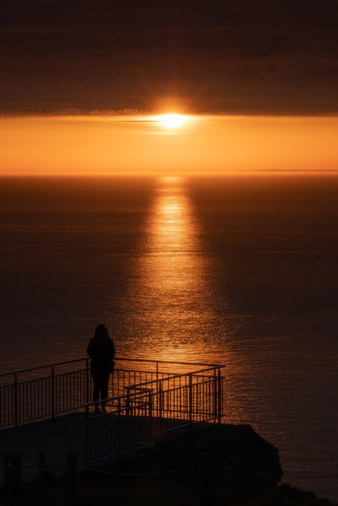Woman watching the sunset at Blanc-Nez cap, France